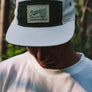 hemp 5 panel cap in natural color with coyote patch on model