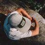 hemp 5 panel cap in natural color with coyote patch top on model