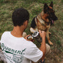 Hemp t-shirt with green coyote print on back on model with dog and coffee