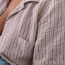 short sleeve hemp shirt with coconut buttons close up on female