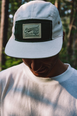 hemp 5 panel cap in natural color with coyote patch on model