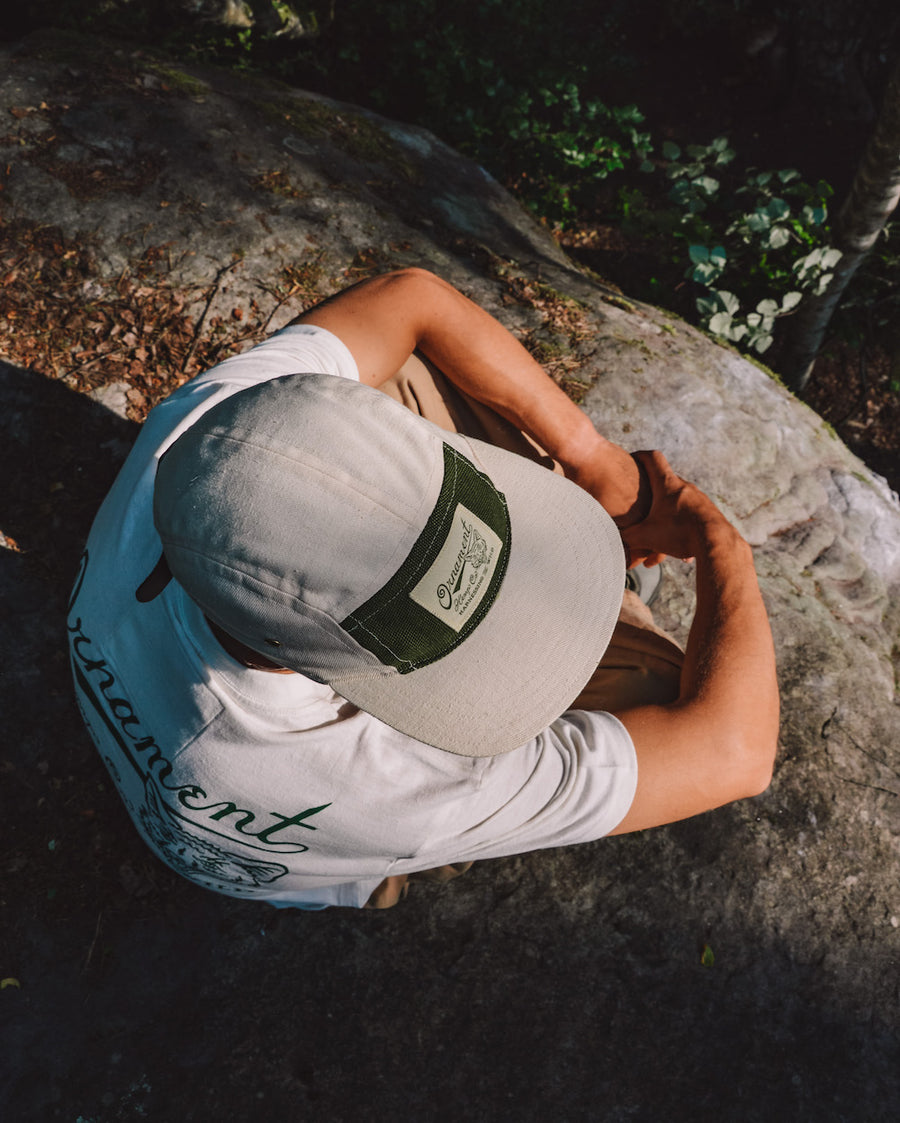 hemp 5 panel cap in natural color with coyote patch top on model
