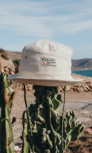 hemp bucket hat in off-white natural color with green string and metal ventilation holes
