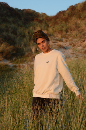 Hemp and bamboo fleece sweater with metal pin in natural color on female model